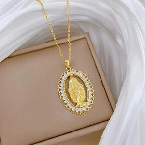 Detail of gold oval pendant with Virgin Mary relief and sparkling crystal halo decoration