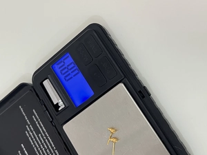 Macro shot showing 0.87g weight of gold plated 925 sterling silver croissant stud earring