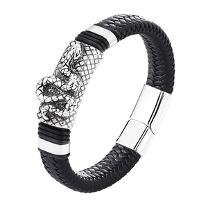 Detailed view of black braided leather bracelet featuring silver dragon scale metal clasp