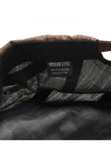 Care label of plaid newsboy cap showing 35% polyester and 65% cotton blend fabric
