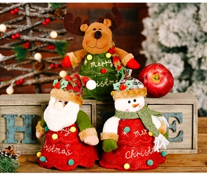 Close-up of Santa, Reindeer, and Snowman plush dolls for Christmas decorations