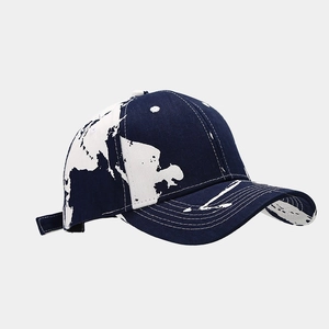 Detail showing white world map print and stitching on navy blue baseball cap