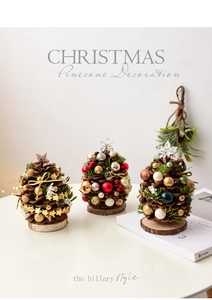 Detail of mini pine cone Christmas trees with colorful ornaments on wooden bases
