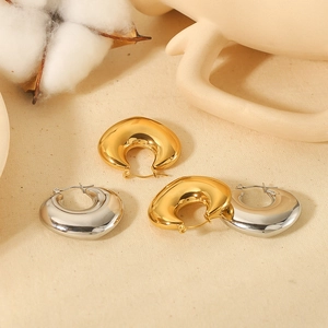 Polished 18K gold and silver chunky C-shaped hoop earrings in minimalist style