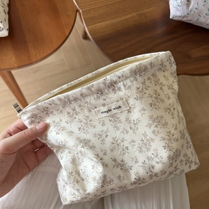 Floral cotton makeup bag with simple wish label and top zipper closure for travel storage