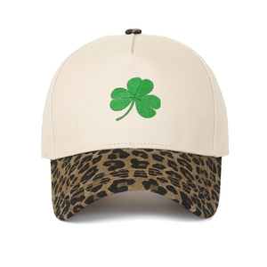 Close-up of green shamrock embroidery on cream crown with leopard print brim baseball cap