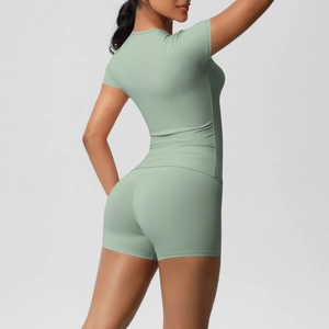 Detail view of high-stretch sage green sports set with slim fit top and high waist shorts