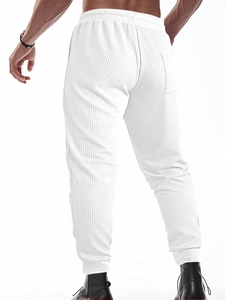 Detail of white waffle knit texture and back pocket on men's jogger trousers