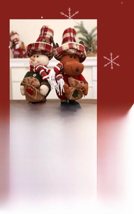 Detail of plush Christmas snowman and reindeer dolls with festive plaid hats and scarves