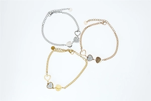 Detailed close-up of heart-shaped bracelets in silver gold and rose gold with rhinestones