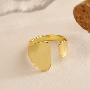 Minimalist 18K gold plated geometric open ring with irregular smooth facets shown from 45-degree angle