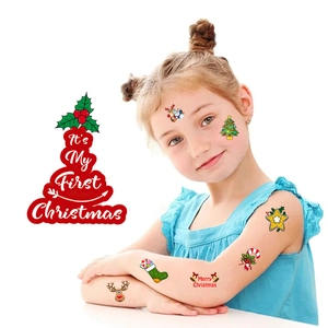 Close-up of colorful Christmas temporary tattoos on child's skin for holiday parties