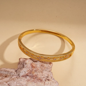 Detail of 18k gold plated hollow flower bangle with sparkling cubic zirconia insets