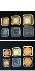 Detail view of square PET mooncake trays in gold and transparent finishes with size markings