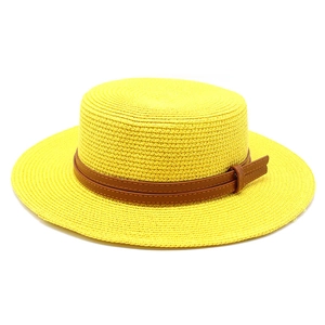 Detail of yellow flat top straw hat with brown leather belt and metallic buckle