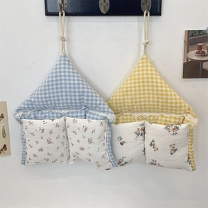 House-shaped hanging wall organizer with plaid and floral fabric pockets and lace trim