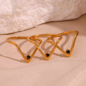 Close-up of three 18K gold plated V-shaped rings with micro-set black square gemstones