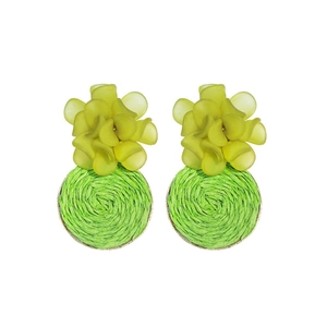 Close-up of yellow 3D flower and green raffia woven round disc earring details