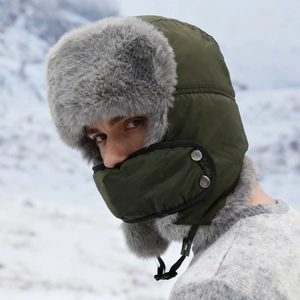Army green winter trapper hat with gray faux fur trim and integrated face mask for skiing