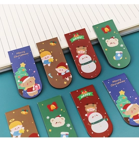 Detailed set of eight festive Christmas magnetic bookmarks on a blue notebook surface