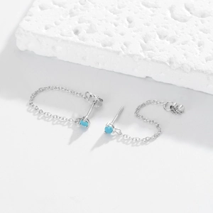 Detailed shot of S925 sterling silver chain earrings with round sky blue zircon stones