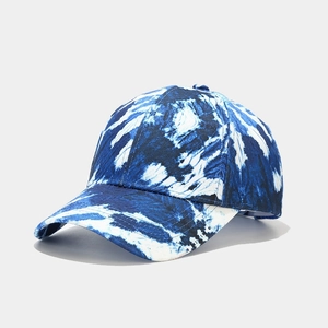 Detail view of cotton baseball cap with artistic blue and white tie-dye patterns