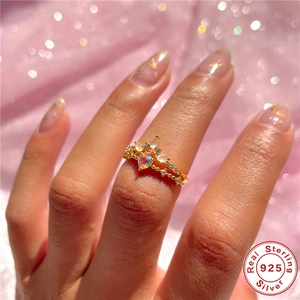 Close-up of dual stacked 925 sterling silver rings with pink heart stone on a hand