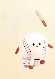 Detailed view of soft baseball plush toy with smiley face and mini bat on book decor