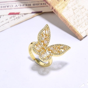 Close-up of golden butterfly open ring featuring detailed pavé cubic zirconia setting