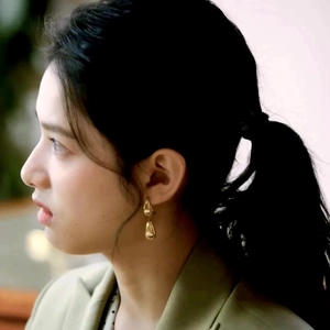 Elegant gold teardrop earrings for women shown on a model for a minimalist jewelry look