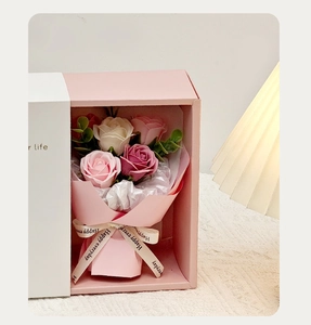 Detailed close-up of pink and white soap flower bouquet in a gift box with ribbons