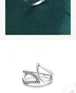 Detail showing S925 hallmark on minimalist silver leaf cross ring with sparkling crystals