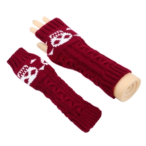 Detail of red cable knit arm warmers with white cat pattern and ribbed thumb hole cuff