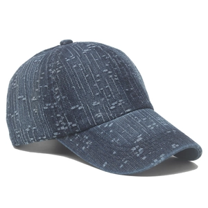 Detailed view of the distressed denim baseball cap featuring unique vertical frayed edges