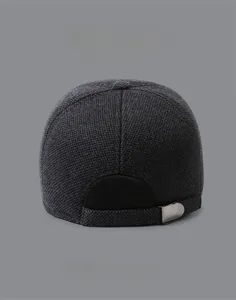 Detail view of the back of a dark grey knit baseball cap with adjustable metal buckle