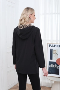 Detail of hooded jacket showing leopard print lining and premium matte black fabric
