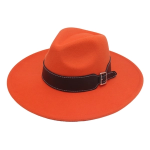 Detail of the high-quality orange wool felt fedora with a black leather belt and silver buckle