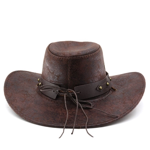 Detail of dark brown faux leather cowboy hat with metal studs and distressed texture