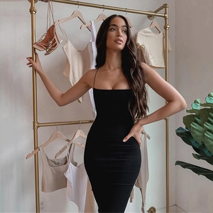 Detail view of the elegant square neck and slim straps of a black midi bodycon dress