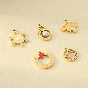 Detail view of gold-plated charms with enamel heart, star, and lightning bolt shapes