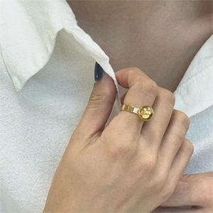 Detail of 925 sterling silver golden ring with a large polished ball bead on finger