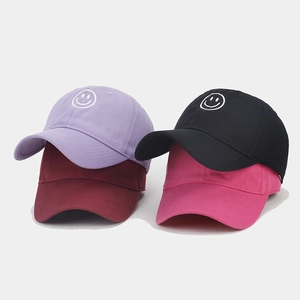 Close-up of smile embroidery on soft cotton baseball caps in multiple colors