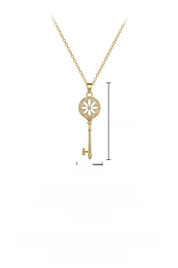 Close-up of golden sunflower key pendant with sparkling crystal inlay on a titanium chain