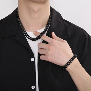 Close-up of matte black titanium steel Cuban link chain necklace and bracelet set for men