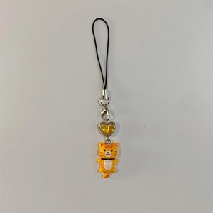 Detail of orange tiger charm with yellow heart bead and black lanyard for phone