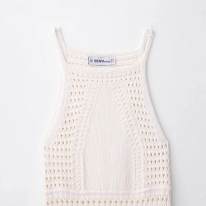 Chic white crochet knit halter mini dress with intricate openwork details for women