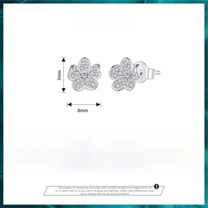Macro detail of S925 sterling silver flower stud earrings with CZ pave setting