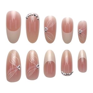 Elegant nude French press-on nails with white ribbon patterns and pearl rhinestones