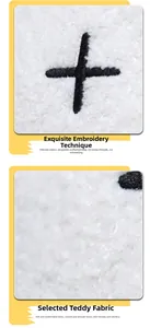 Detail of soft white teddy velvet fabric with high-quality black cross embroidery