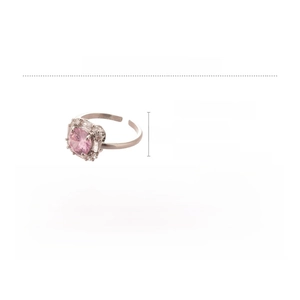 Macro shot of silver ring featuring a pink square zircon surrounded by small white stones